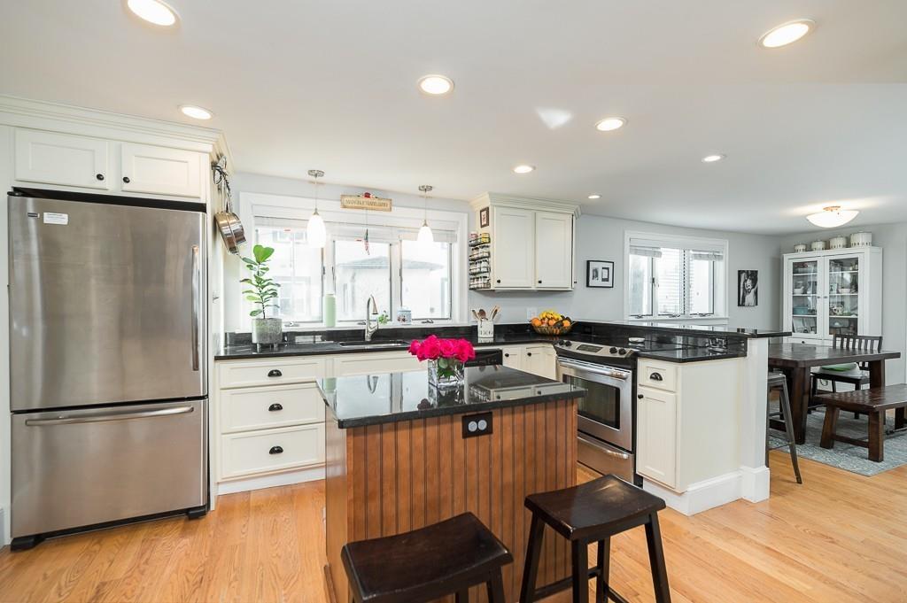 16 Bartlett Street Beverly, MA 01915 - Photo 3 of 28 a kitchen with kitchen island granite countertop wooden floors and appliances