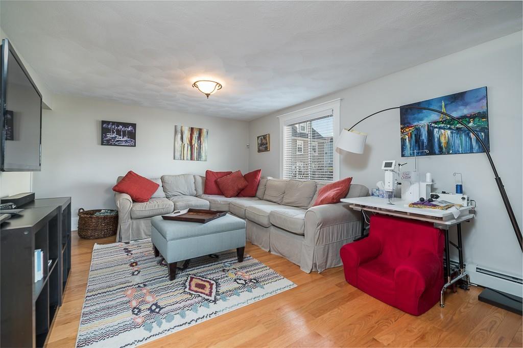 16 Bartlett Street Beverly, MA 01915 - Photo 8 of 28 a living room with furniture and a flat screen tv