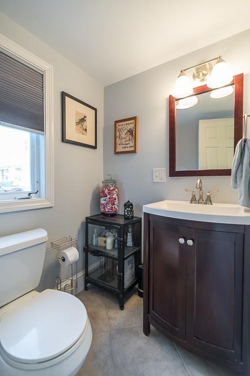 16 Bartlett Street Beverly, MA 01915 - Photo 9 of 28 a bathroom with a toilet a sink and mirror