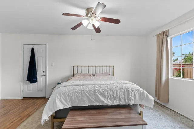 a bedroom with a large bed and a chandelier