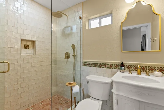 a bathroom with a sink toilet and shower
