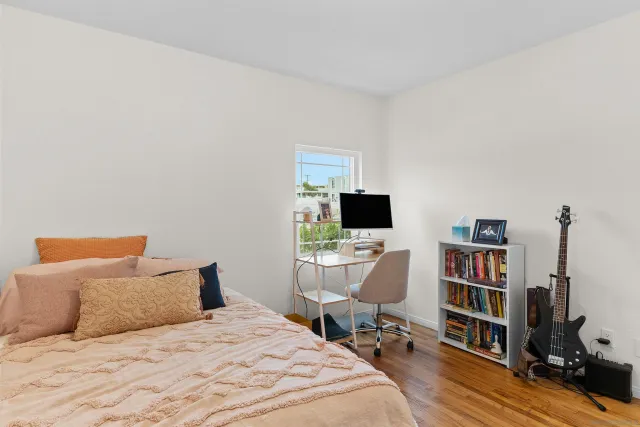 a bedroom with a bed and a desk