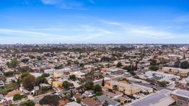 an aerial view of a house with garden space and street view