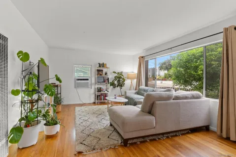 a living room with furniture and a large window