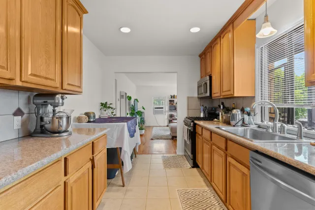 a kitchen with a sink a counter top space and cabinets