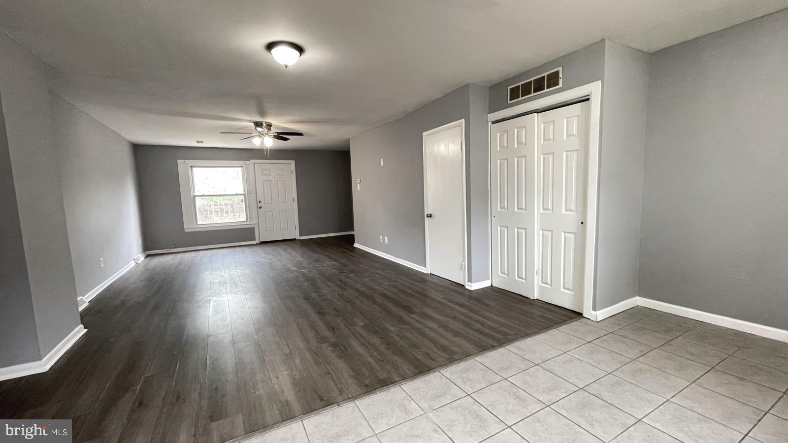 1340 West 7th Street Chester, PA 19013 - Photo 7 of 26 an empty room with wooden floor and windows