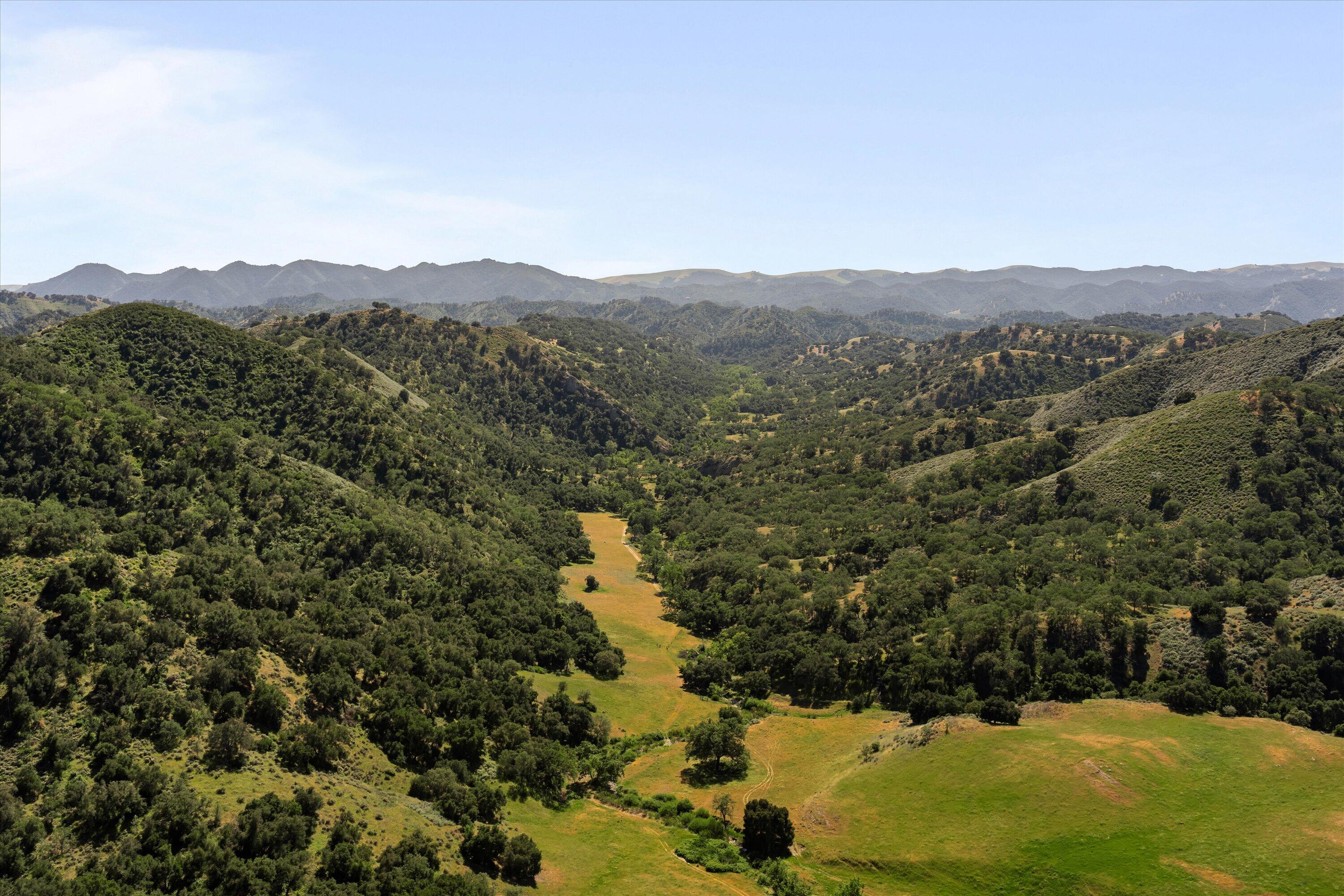12707 Huasna Road Arroyo Grande, CA 93420 - Photo 72 of 77 a view of a lush green field with mountains in the background