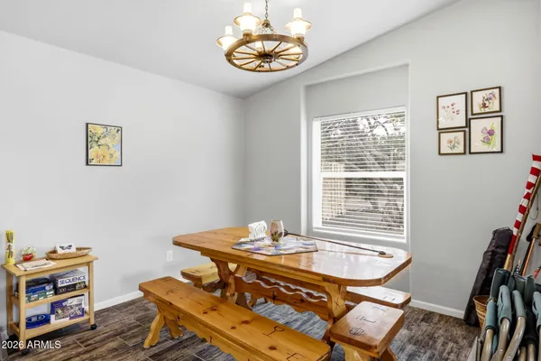 a living room with furniture kitchen view and a chandelier