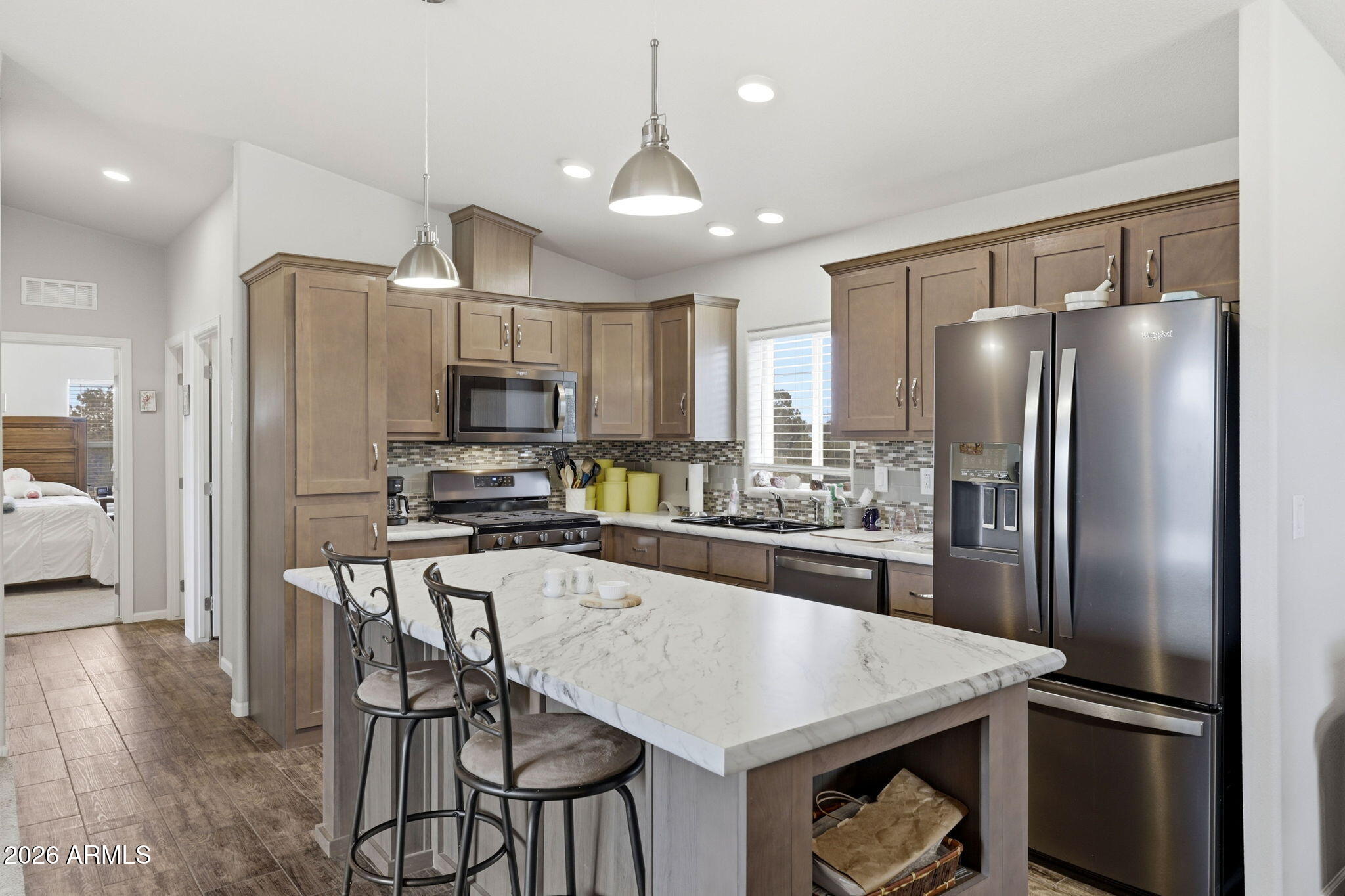 2145 Pulp Mill Road Clay Springs, AZ 85923 - Photo 11 of 33 a kitchen with kitchen island a refrigerator stove microwave and cabinets