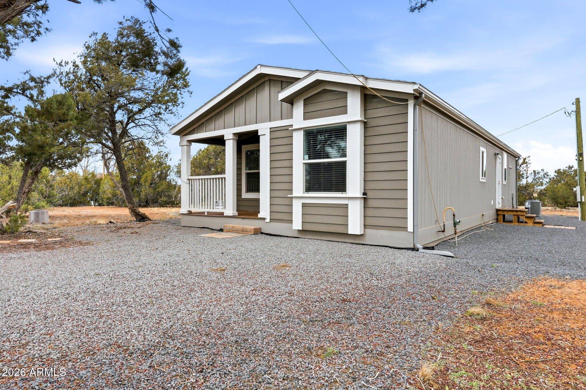 2145 Pulp Mill Road Clay Springs, AZ 85923 - Photo 2 of 33 a front view of a house with a yard