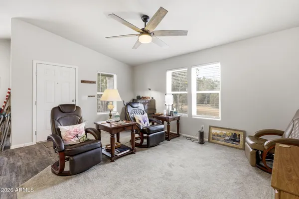 a view of a workspace with furniture and a window