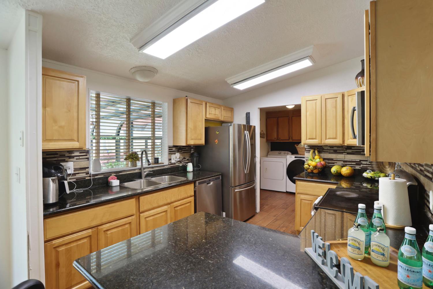 901 Quail Oaks Road Valley Springs, CA 95252 - Photo 11 of 59 a kitchen with stainless steel appliances granite countertop a sink stove and refrigerator