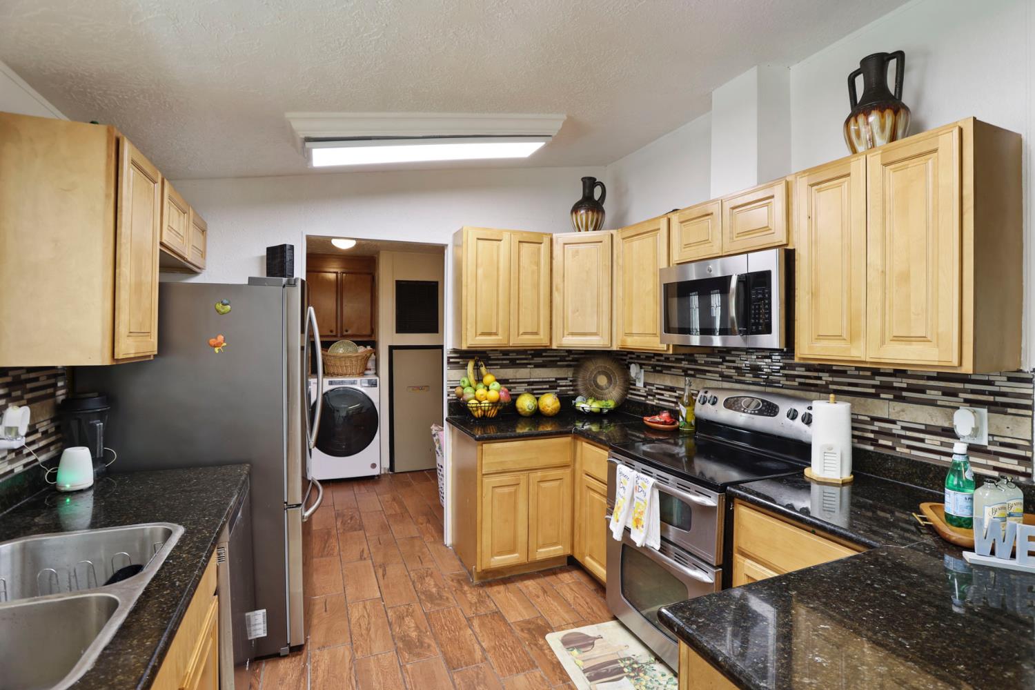 901 Quail Oaks Road Valley Springs, CA 95252 - Photo 13 of 59 a kitchen with a refrigerator a stove and a sink