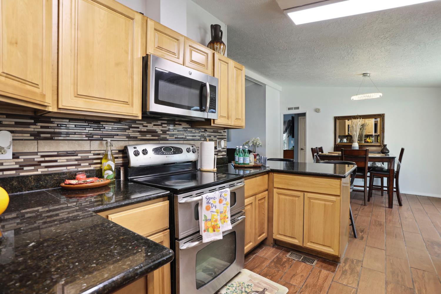 901 Quail Oaks Road Valley Springs, CA 95252 - Photo 14 of 59 a kitchen with stainless steel appliances granite countertop a stove a sink and a microwave