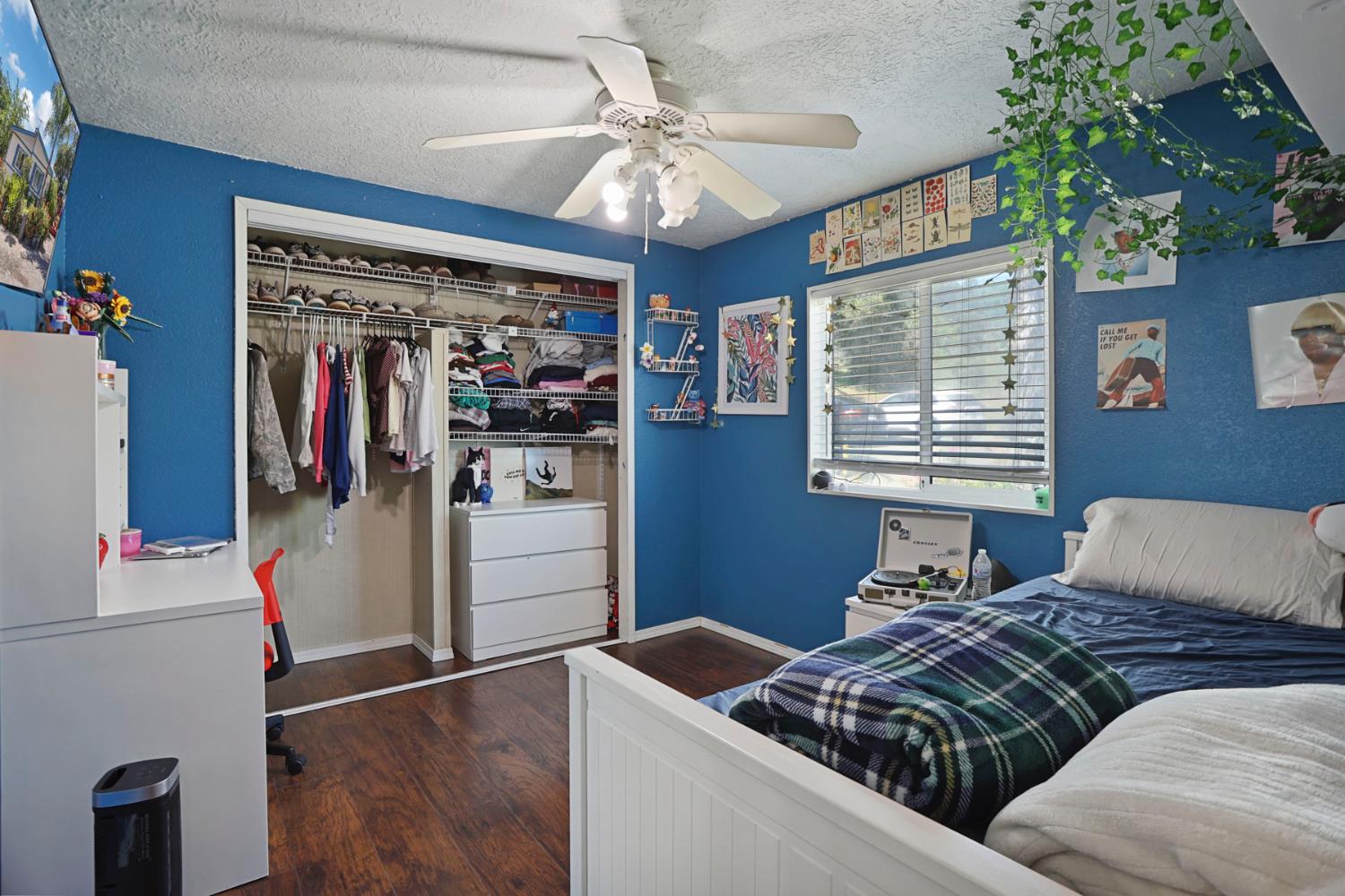 901 Quail Oaks Road Valley Springs, CA 95252 - Photo 21 of 59 a bedroom with a bed and a chandelier