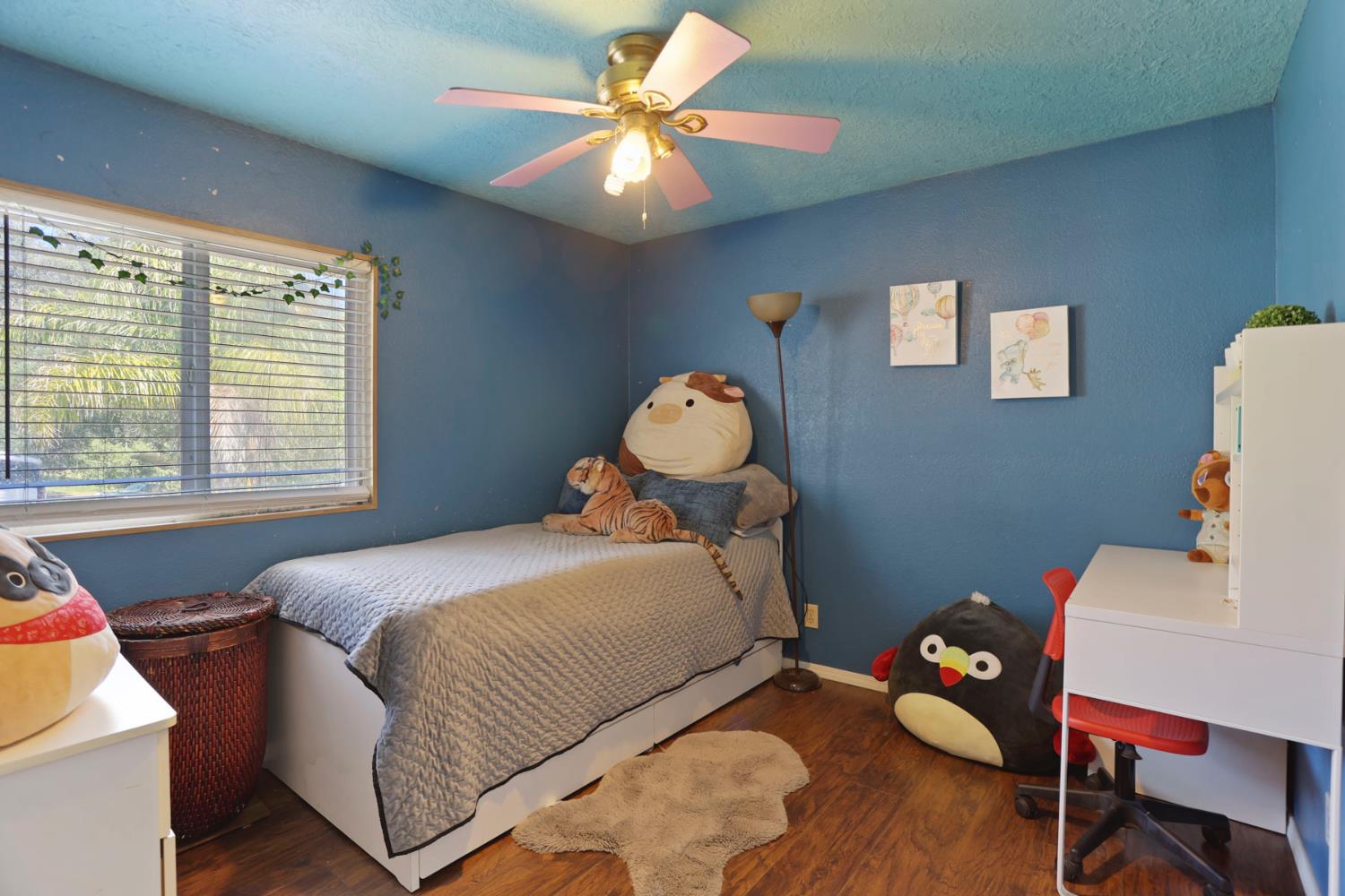 901 Quail Oaks Road Valley Springs, CA 95252 - Photo 26 of 59 a bedroom with a bed and a chandelier