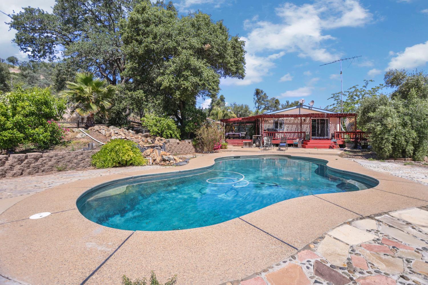 901 Quail Oaks Road Valley Springs, CA 95252 - Photo 34 of 59 a view of a swimming pool with a yard