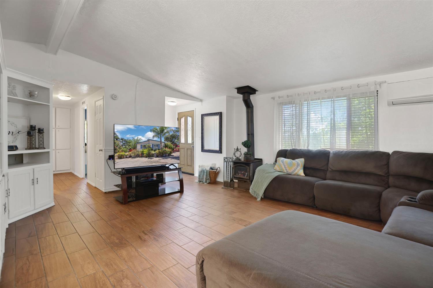 901 Quail Oaks Road Valley Springs, CA 95252 - Photo 4 of 59 a living room with furniture and a wooden floor