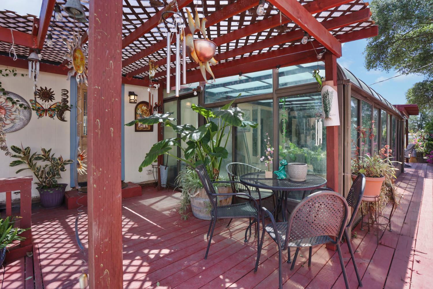 901 Quail Oaks Road Valley Springs, CA 95252 - Photo 42 of 59 a view of an outdoor dining space with a table and chairs