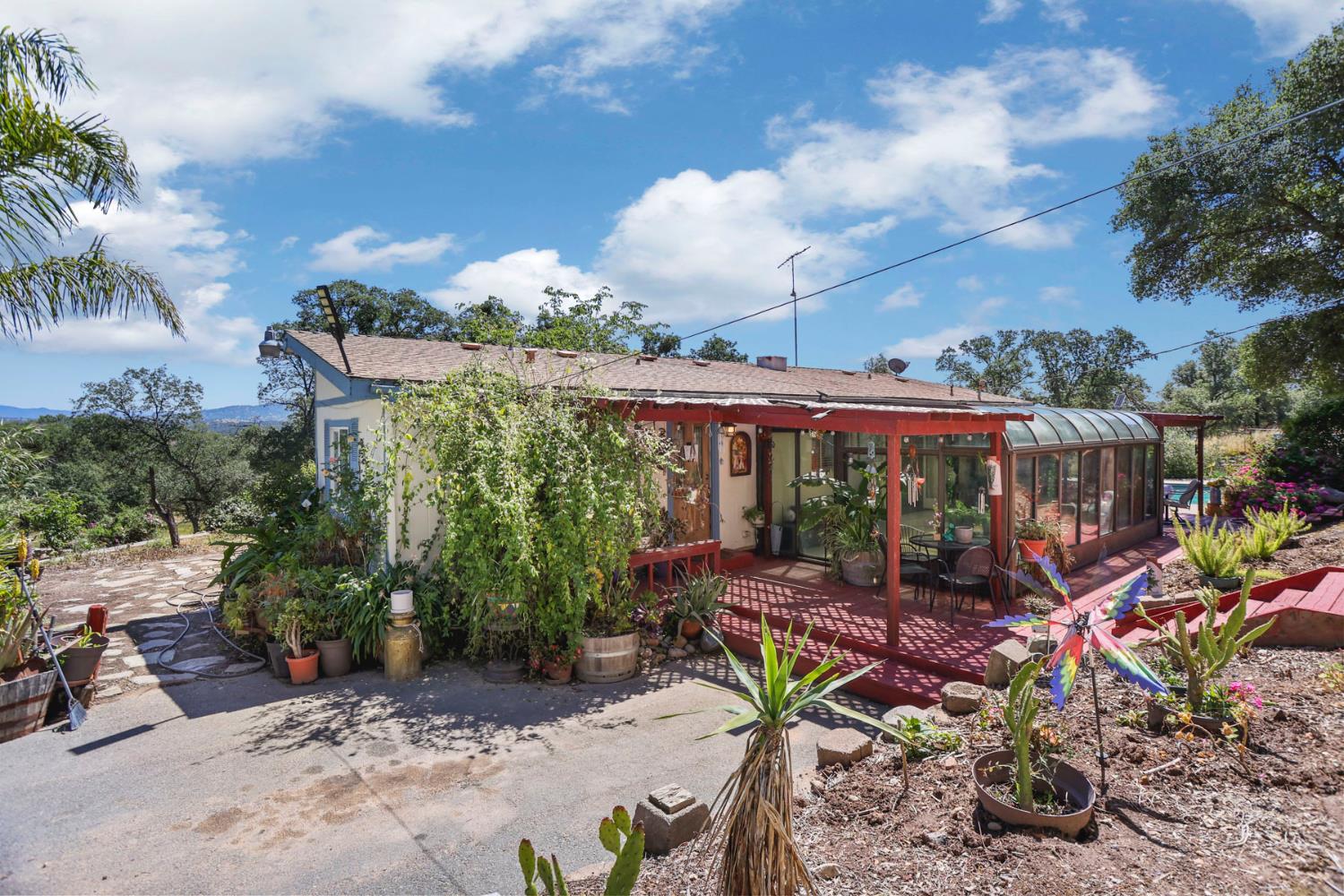 901 Quail Oaks Road Valley Springs, CA 95252 - Photo 43 of 59 a view of a patio with table and chairs potted plants