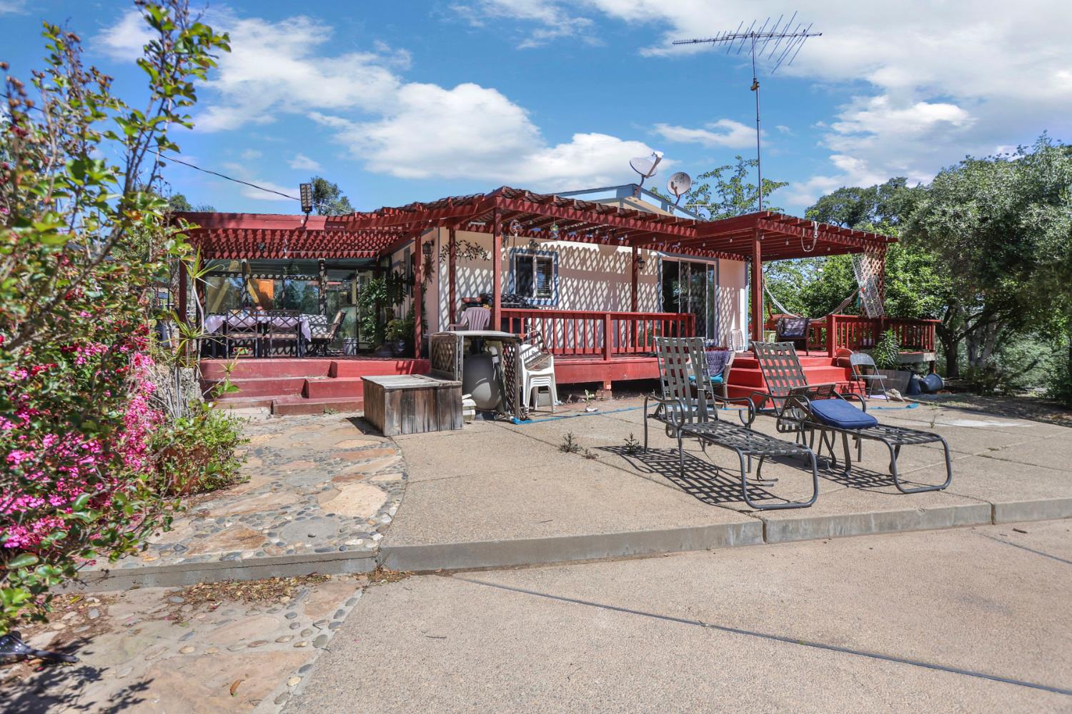 901 Quail Oaks Road Valley Springs, CA 95252 - Photo 46 of 59 a view of a patio with a table and chairs and potted plants