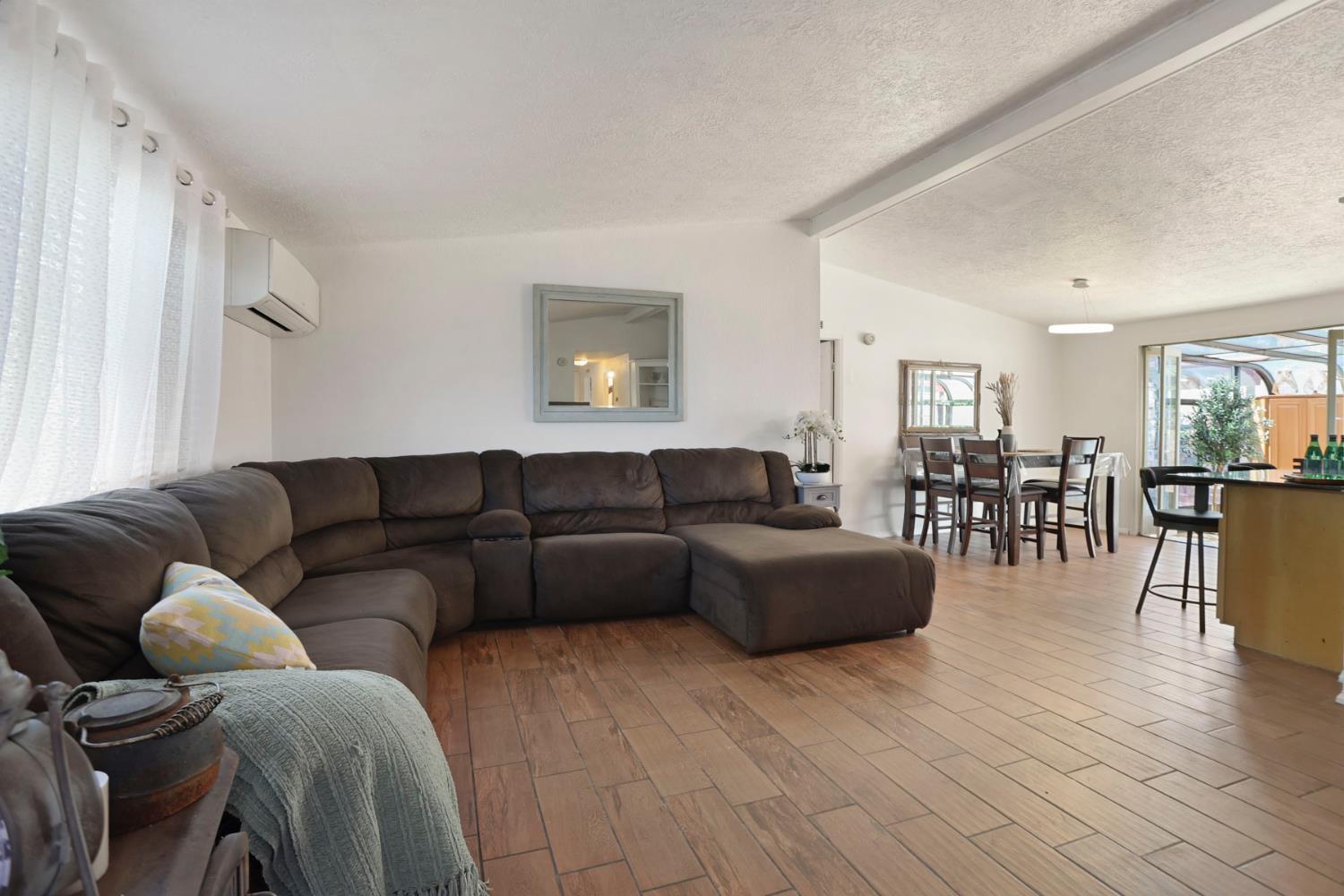 901 Quail Oaks Road Valley Springs, CA 95252 - Photo 6 of 59 a living room with furniture and a wooden floor