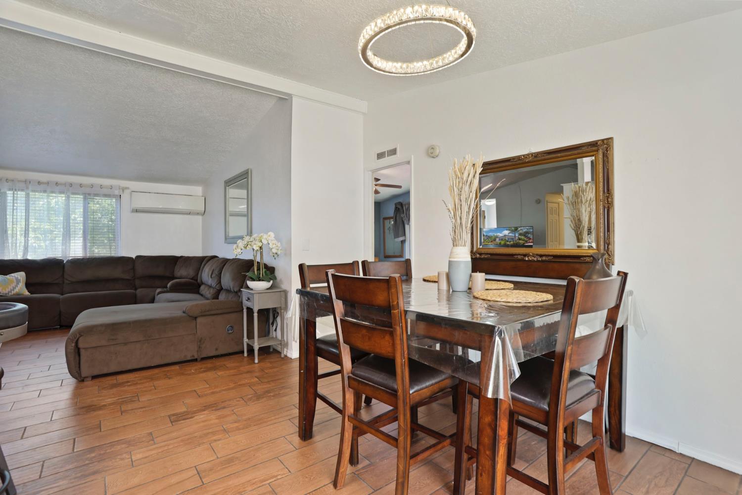 901 Quail Oaks Road Valley Springs, CA 95252 - Photo 8 of 59 a living room with furniture and a wooden floor