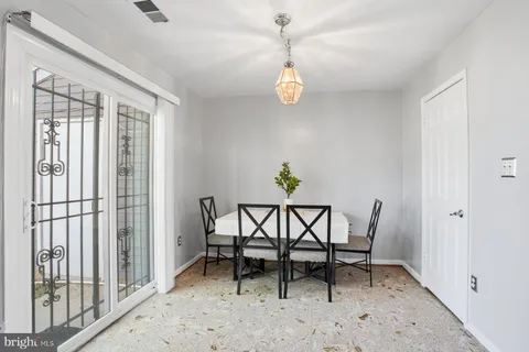 a view of a dining room and hall with furniture