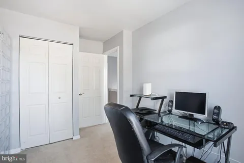 a view of a workspace with furniture and a flat screen tv