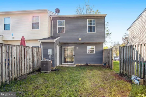 a view of a house with wooden fence