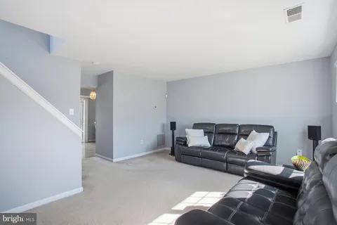 a living room with furniture and white walls