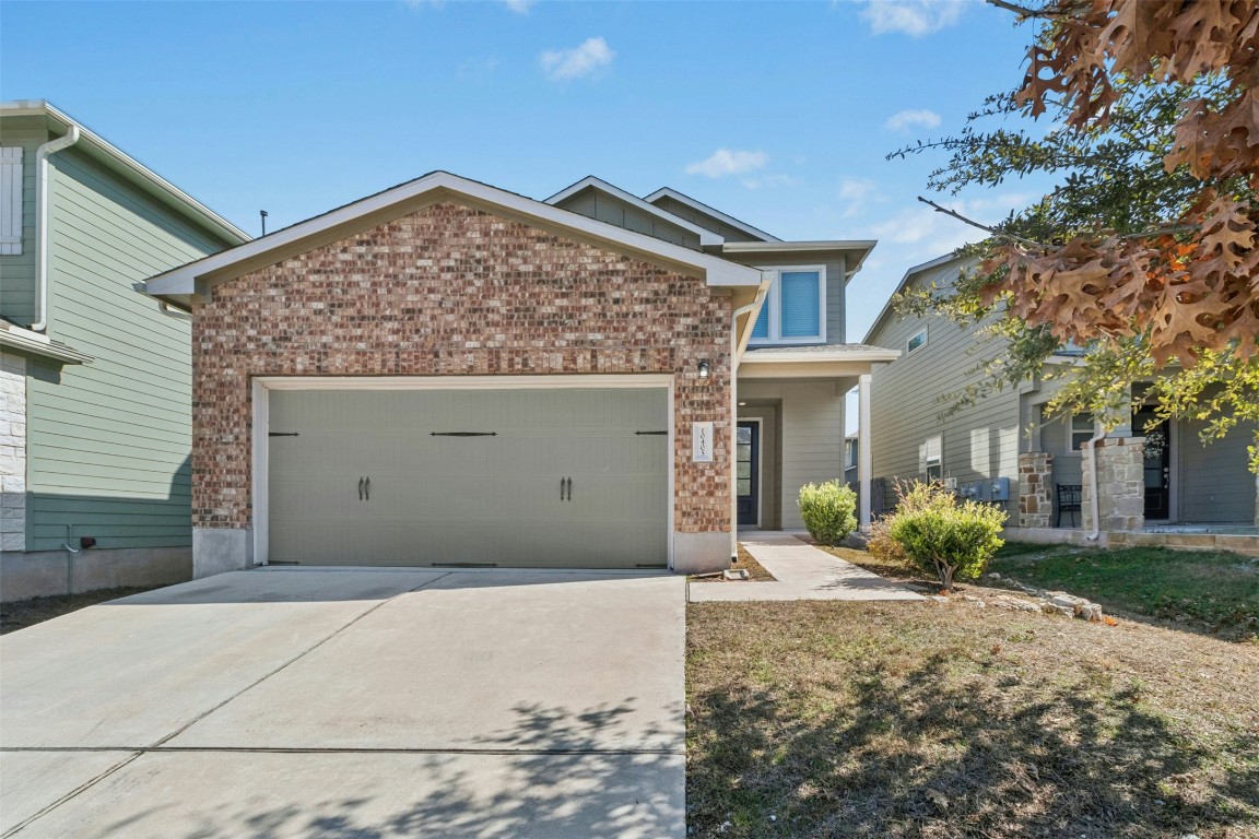 10405 Tree Duck Drive Austin, TX 78748 - Photo 1 of 33 View of front of property featuring brick siding, driveway, and a garage