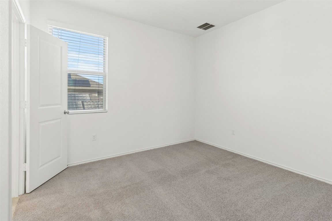 10405 Tree Duck Drive Austin, TX 78748 - Photo 20 of 33 Empty room featuring light carpet and baseboards