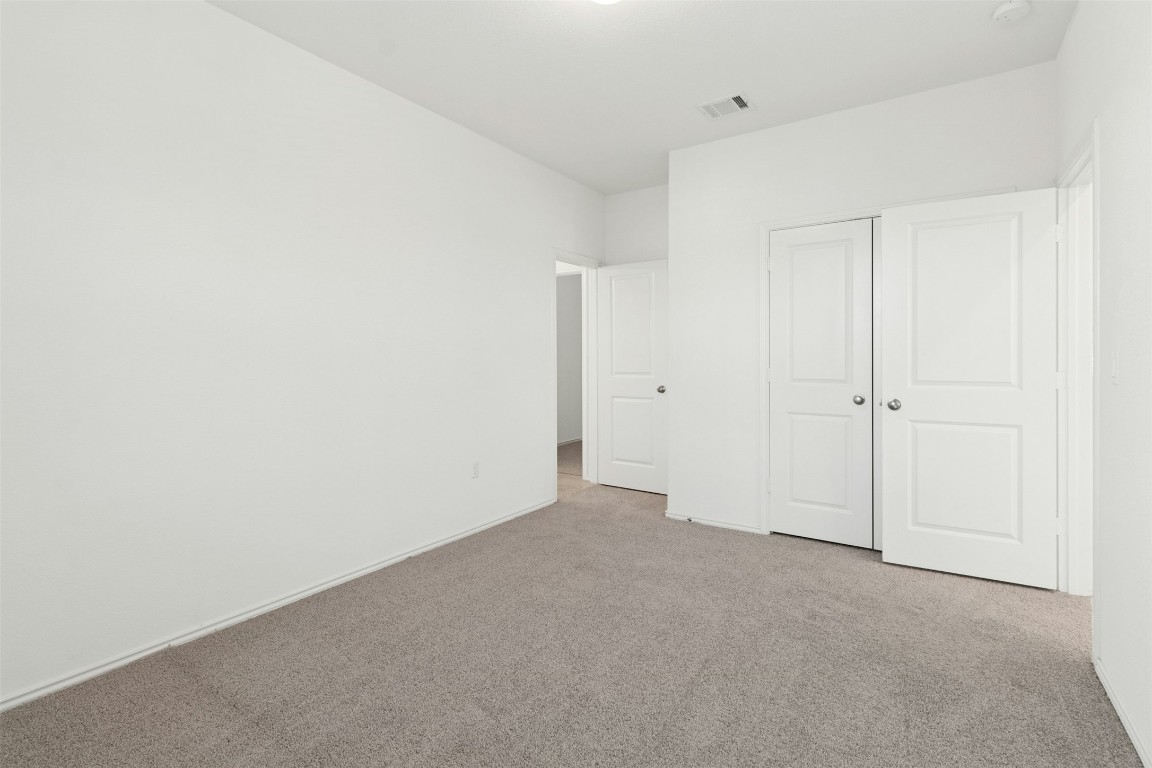 10405 Tree Duck Drive Austin, TX 78748 - Photo 24 of 33 Unfurnished bedroom featuring carpet flooring and a closet