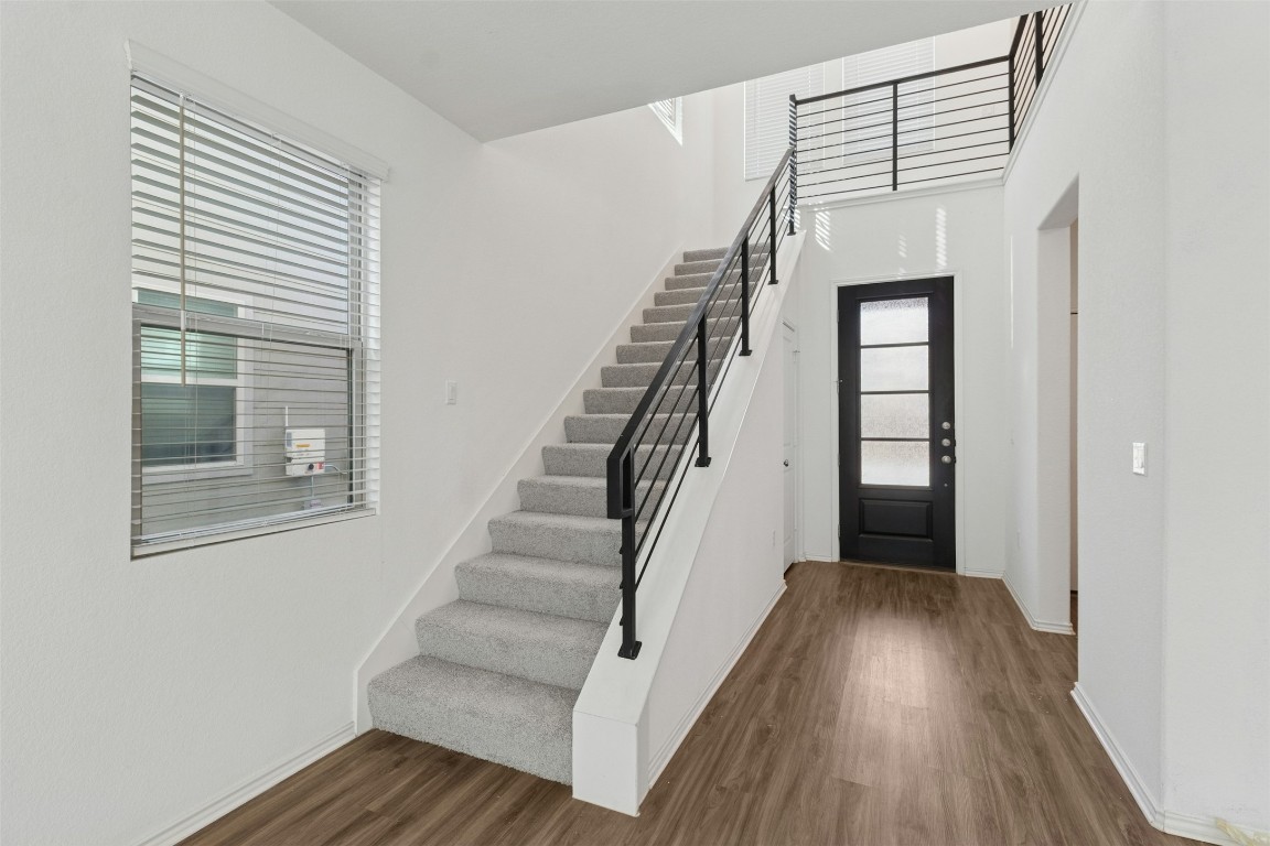10405 Tree Duck Drive Austin, TX 78748 - Photo 4 of 33 Entryway featuring dark wood-style floors, stairway, and a towering ceiling