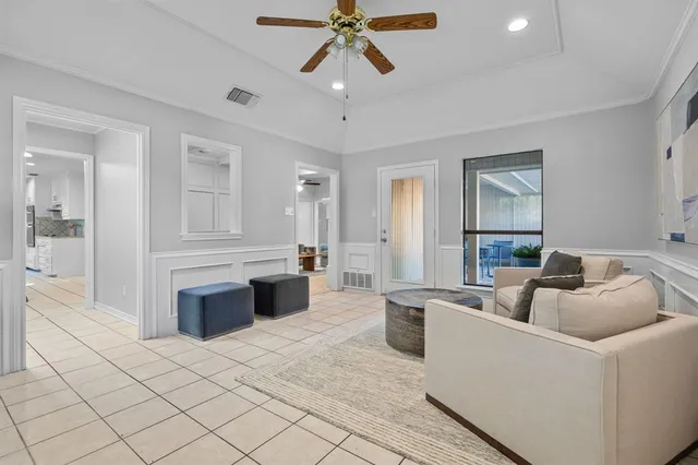 a living room with furniture and a chandelier