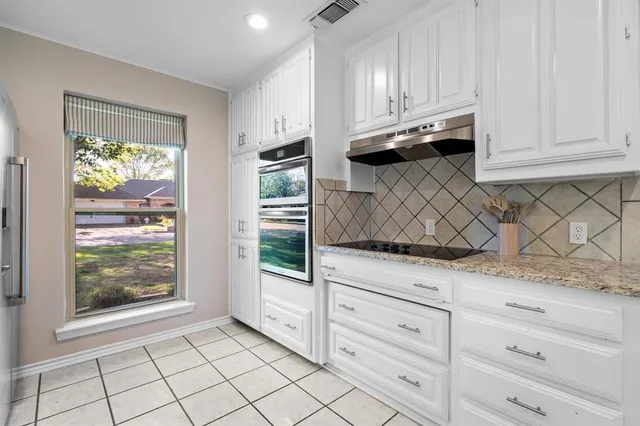 a view of white cabinets and window