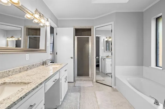 a spacious bathroom with a granite countertop tub sink and mirror
