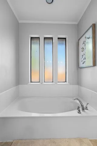 a white bath tub sitting next to a window