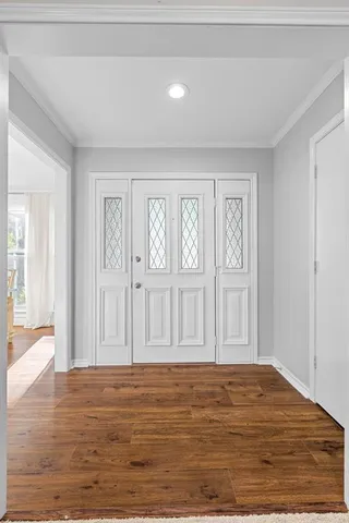 a view of empty room with wooden floor