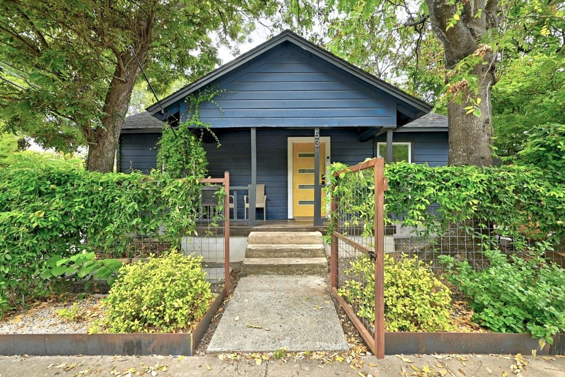 a front view of a house with garden