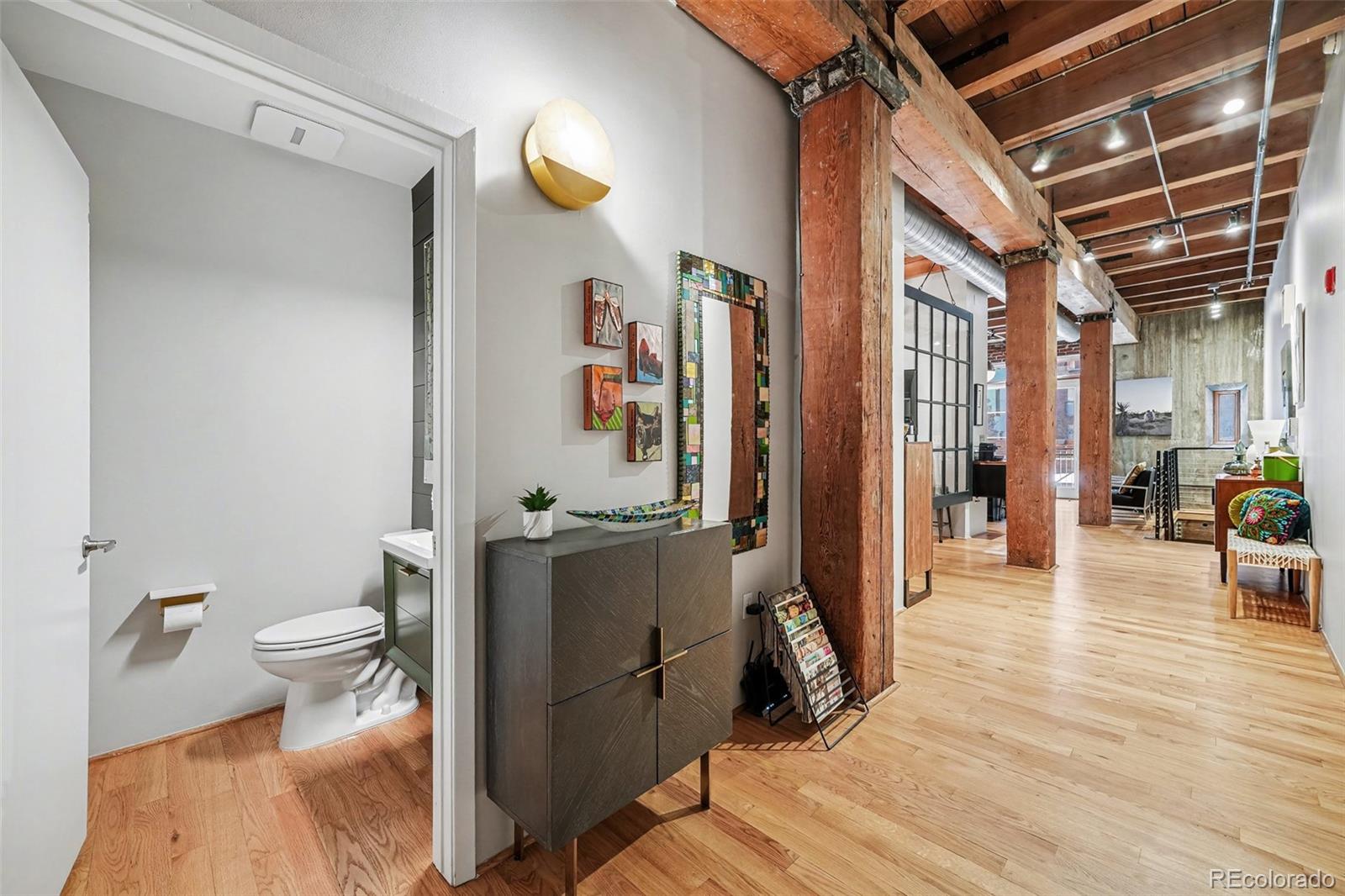 2960 Inca Street, Unit 103 Denver, CO 80202 - Photo 12 of 28 a living room with furniture and a wooden floor