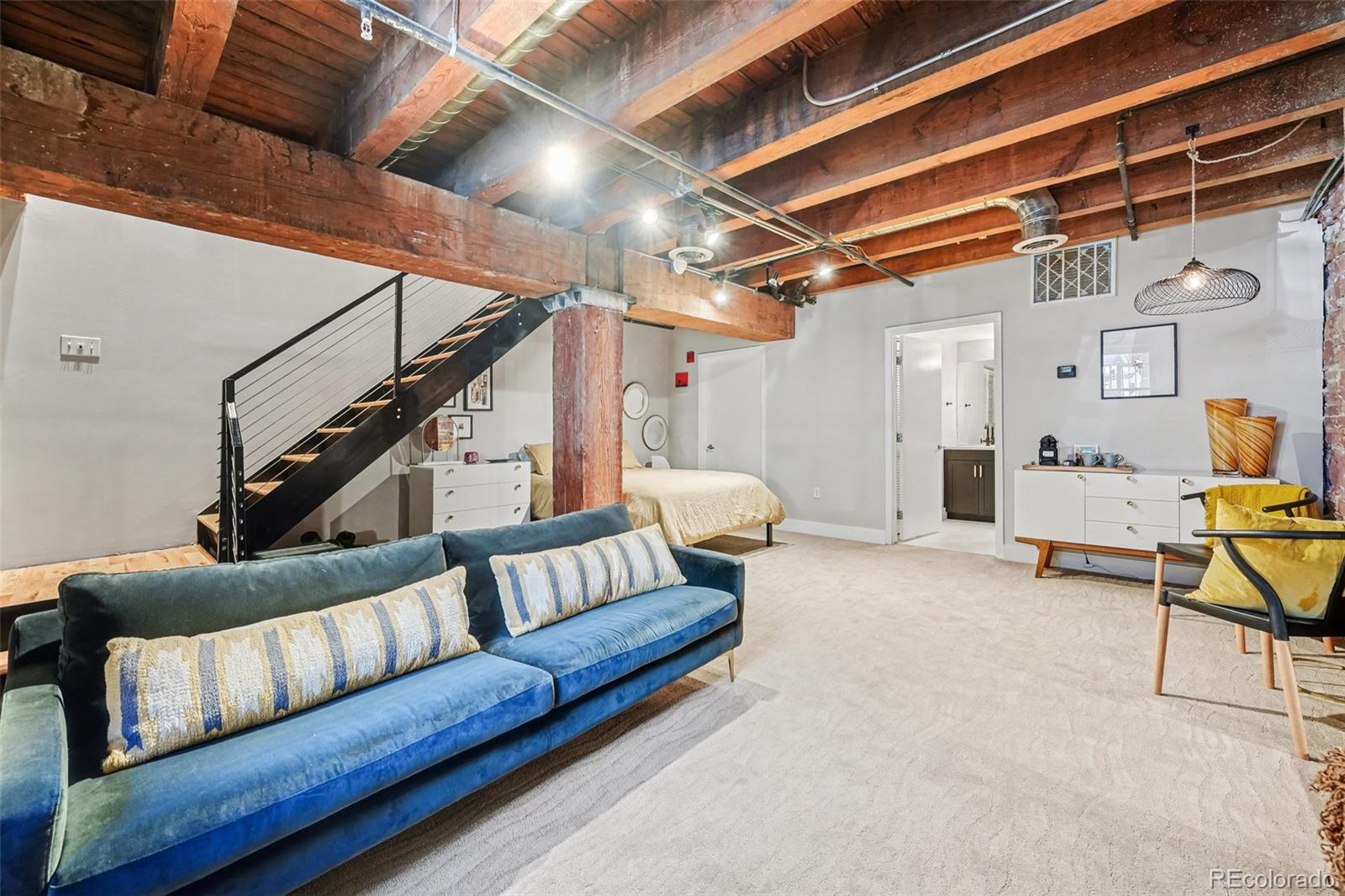 2960 Inca Street, Unit 103 Denver, CO 80202 - Photo 16 of 28 a living room with furniture and a chandelier
