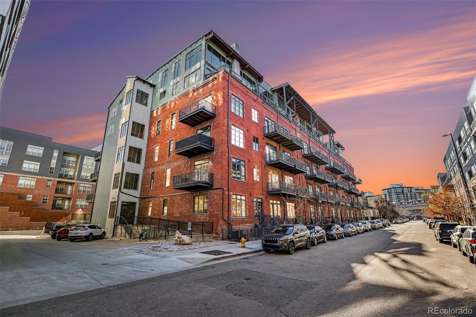 2960 Inca Street, Unit 103 Denver, CO 80202 - Photo 21 of 28 a city street lined with buildings and cars parked on the side of road