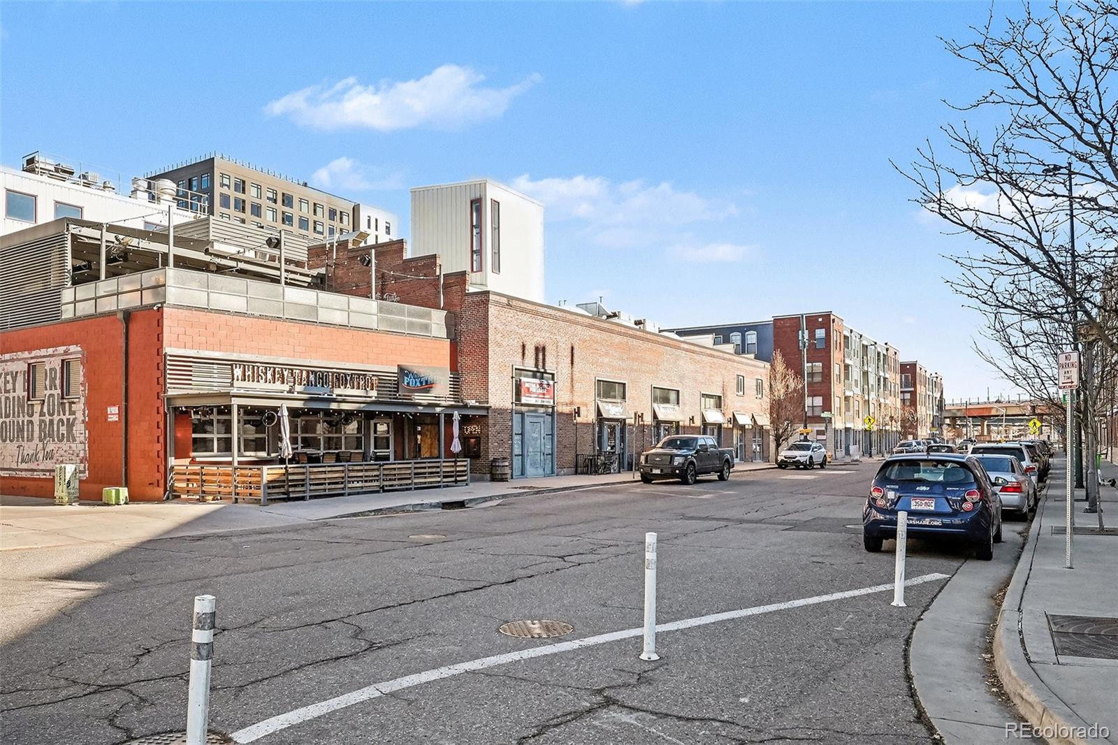 2960 Inca Street, Unit 103 Denver, CO 80202 - Photo 26 of 28 a city street lined with buildings and cars