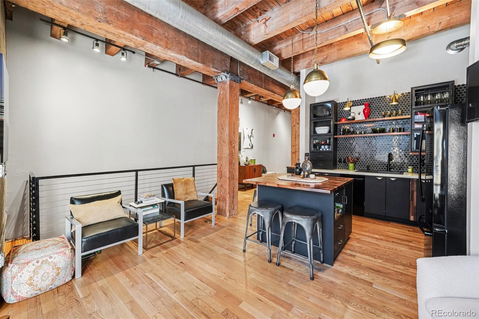 2960 Inca Street, Unit 103 Denver, CO 80202 - Photo 3 of 28 a room with wooden cabinets and stainless steel appliances