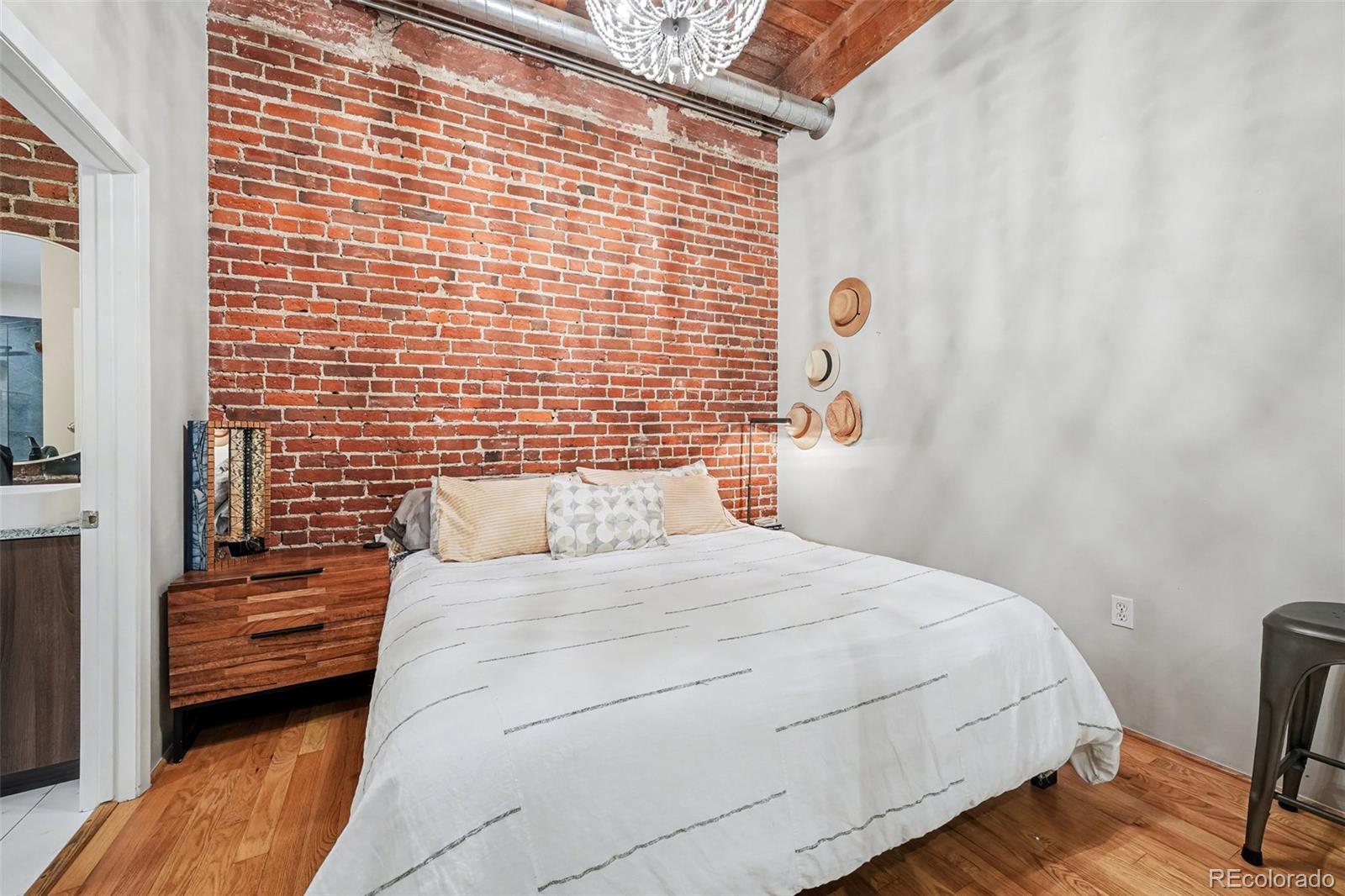 2960 Inca Street, Unit 103 Denver, CO 80202 - Photo 8 of 28 a bedroom with a bed and a window