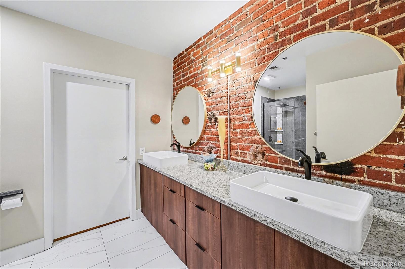 2960 Inca Street, Unit 103 Denver, CO 80202 - Photo 10 of 28 a bathroom with a double vanity sink and a mirror