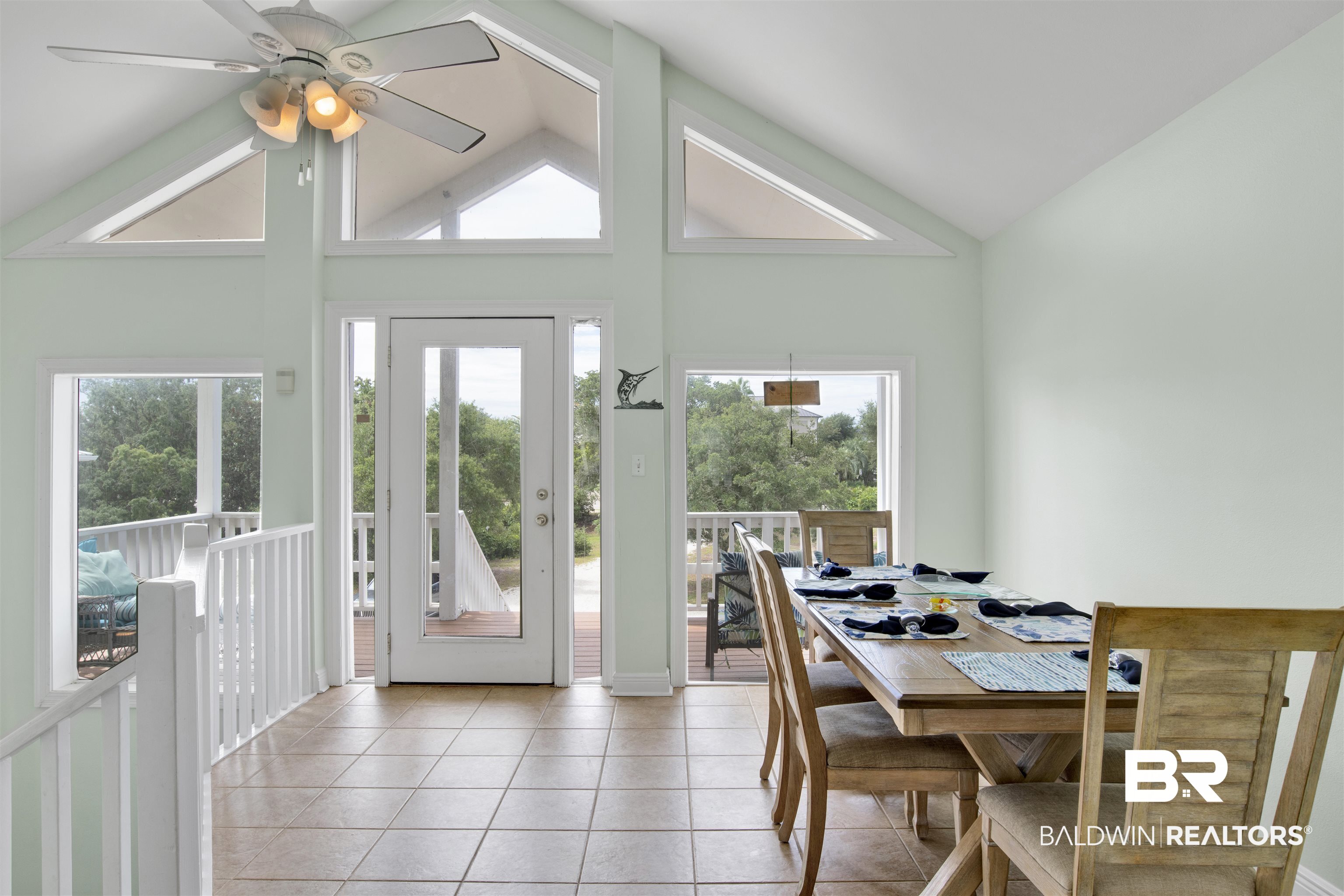 33093 River Road Orange Beach, AL 36561 - Photo 10 of 30 Dining space with plenty of natural light, high vaulted ceiling, ceiling fan, and light tile patterned floors