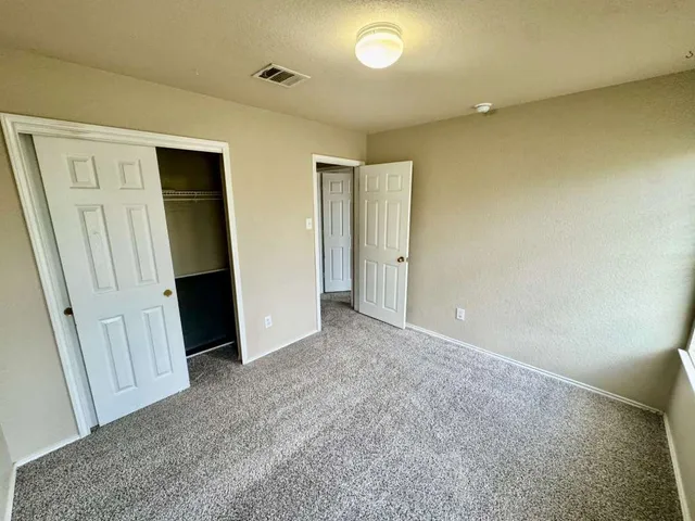 an empty room with closet area